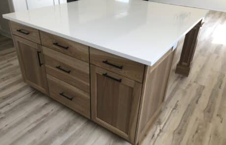 Custom kitchen island with white granite countertop and wood cabinetry