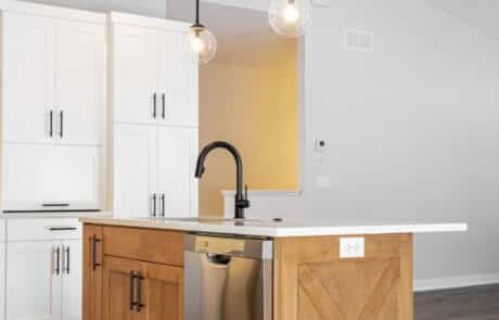 Custom kitchen island with white granite countertop and oak cabinets