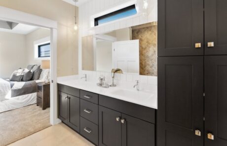 Custom black wooden cabinets for master bathroom, featuring white granite vanity countertop