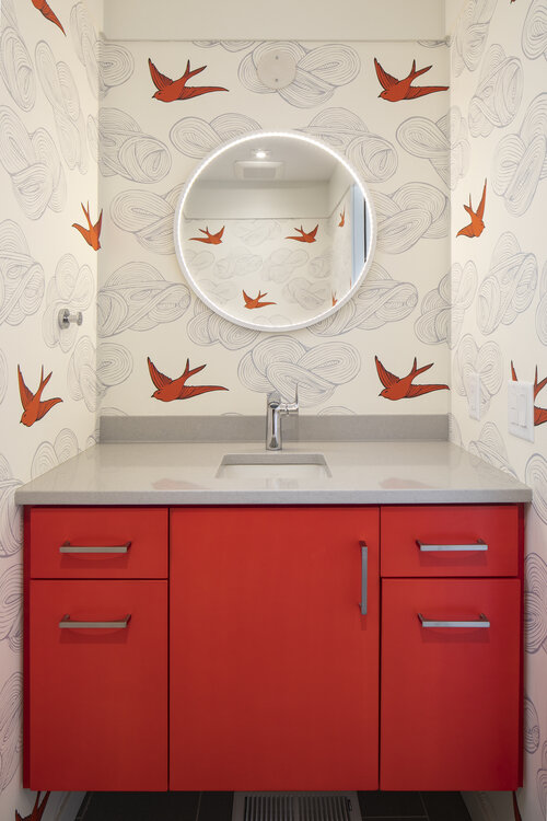 Custom artsy bathroom vanity with modern red cabinets and grey granite counter tops